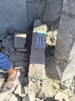 A man walks across a floor piled with rubble